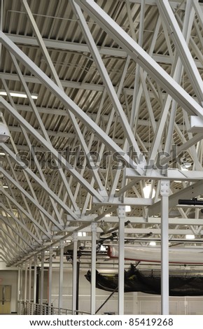 Architectural teamwork: Array of steel beams suspending a running track (not shown) in college gymnasium