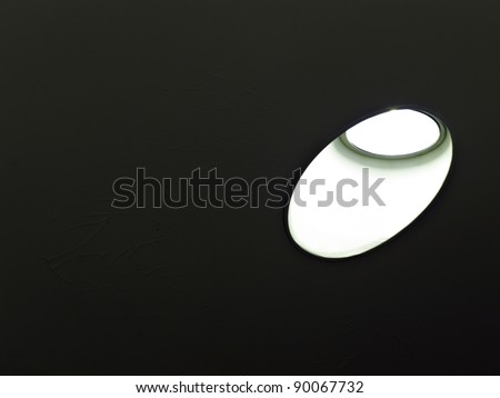 Minimalism in hallway lighting: Ceiling light fixture in angled soffit, with dark textured background