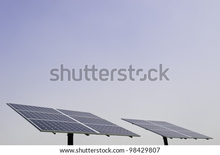 Pair of solar panels with hazy blue sky for copy space