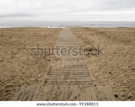 End of the road: Boardwalk across sandy beach to the Atlantic Ocean