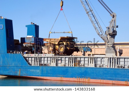 A ship loading earth moving equipment