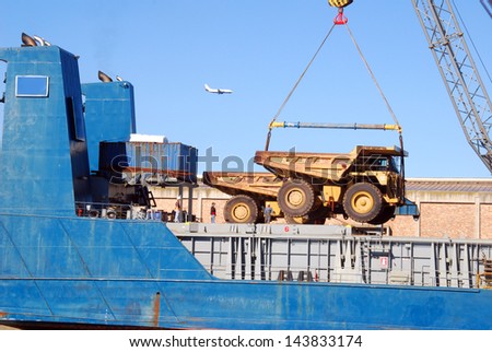 A ship loading earth moving equipment