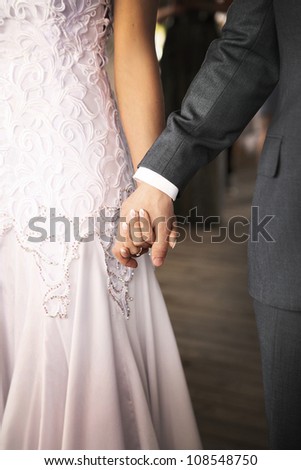 joined hands of newlywedded couple