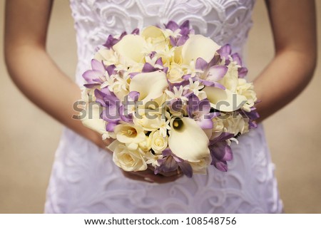 yellow and purple bride\'s bouquet