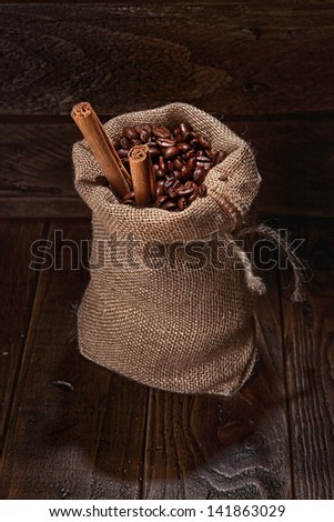 small bag of coffee beans and stick of cinamon