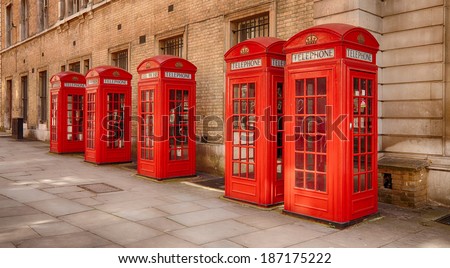 Five traditional old style UK red phone boxes in Covent Garden in London on a sunny day