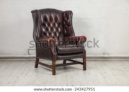 brown classic chair in dusty warehouse space