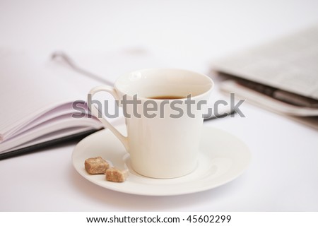cup of coffee, notebook and newspaper