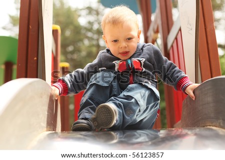 beautiful little boy on the slide
