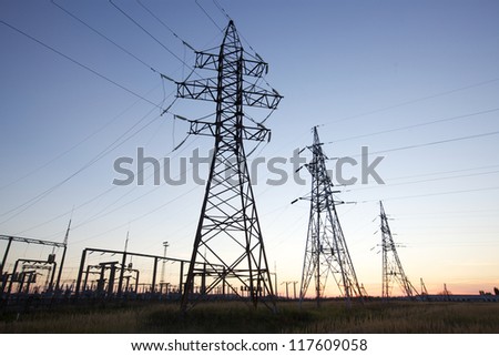 High voltage power lines at twilight at the horizon