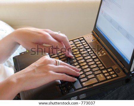 Business womans hands typing on laptop keyboard