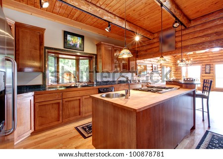 Log cabin large kitchen interior with island.