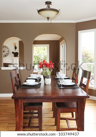 Dining room with brown walls and wood table in the luxury home.