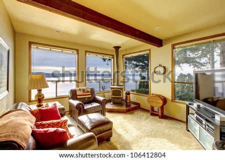 Small cozy living room with TV and water view.
