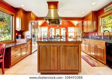 Large red luxury kitchen interior with wood and tiles.