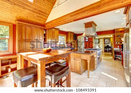 Red large luxury kitchen interior with beautiful wood and tile floor.