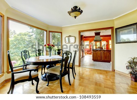 Dining room with large windows and hardwood floor.