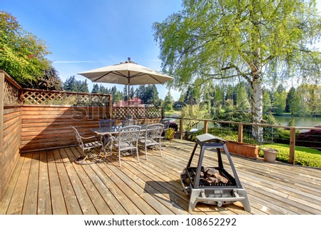 Beautiful spring deck with umbrella and fire pit.