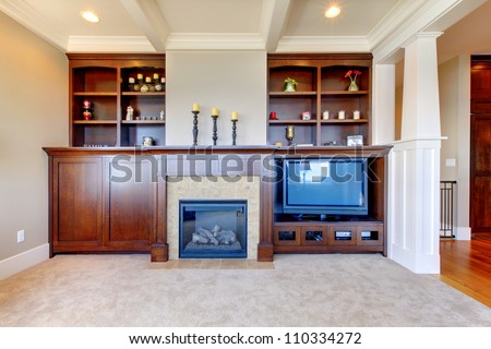 TV and entertainment center with white wood ceiling in a luxury room.