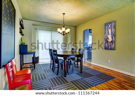 Dining Room With Green Walls, Black Table And Grey Rug With Art ...