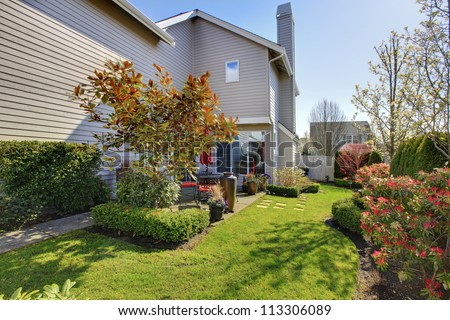 Nicely landscaped back yard with house during spring in NorthWest USA.