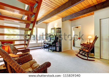Bright Bedroom with red bed, open balcony door and beige walls. Simple American farm house interior.