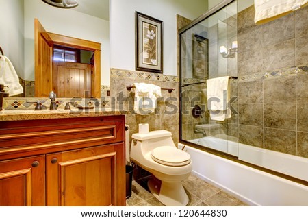 Luxury mountain home bathroom with shower, tub, natural stone tiles.