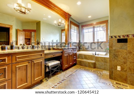 Luxury Large Master Bathroom In Mountain Home With Double Sink And Green Walls.