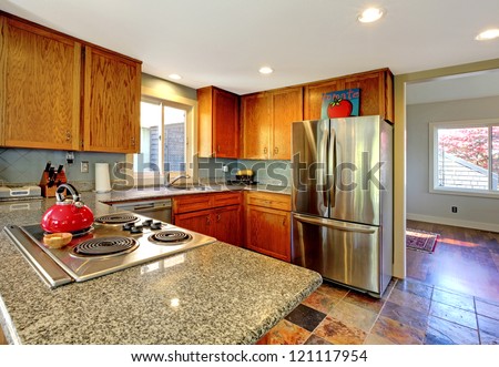 Kitchen With Granite Counter Top Stove And Red Tea Pot  Stock