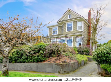 Spring landscape with classic American craftsman style home.