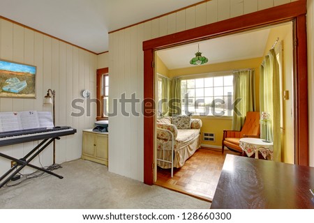 Small music room with sleeping sofa and reading corner in yellow and green.