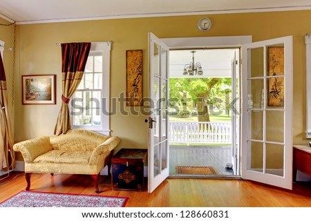 Living Room With Open Doors To The Front Porch. Romantic Classic With Park View.