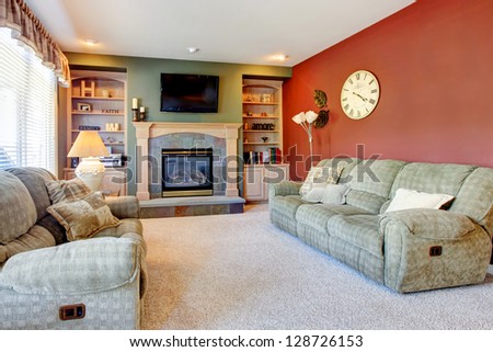 Classic American Cozy Living Room Interior With Fireplace And Red Wall.