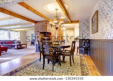 Dining room near brick fireplace and living room. Open floor plan.