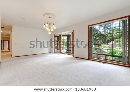 Very Large Empty Living Room With Sliding Doors To The Back Yard.