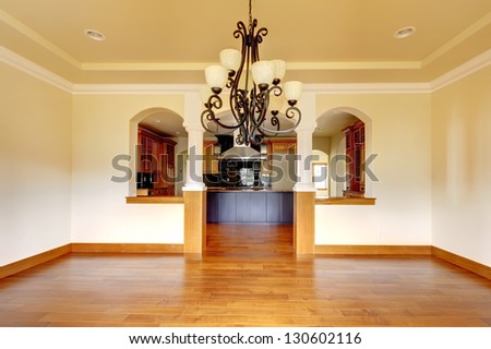 Large luxury dining room interior with kitchen and arch. New empty home.