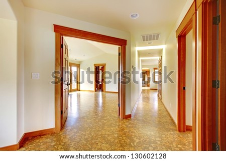 Large hallway in empty house with cork floor. New luxury home interior.