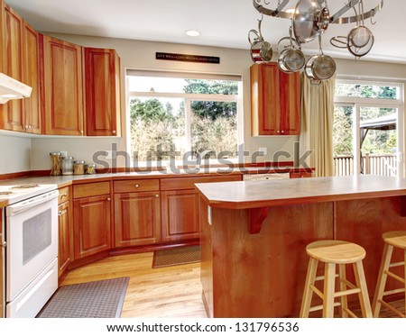 Classic large wood kitchen interior with hardwood floor, breakfast table.