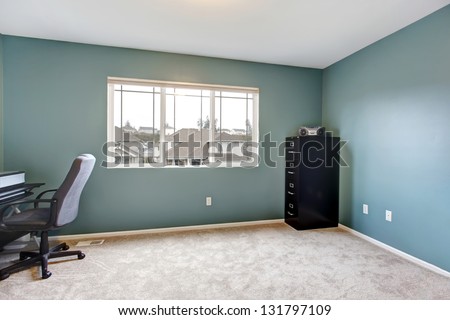 Simple home office room interior with blue walls and almost empty.