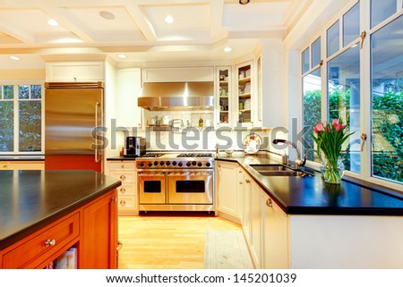 White Large Luxury Kitchen With Huge Stove And Refrigerator.