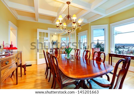 Golden Bright Yellow Luxury Dining Room With Elegant Classic Furniture And White Wood Ceiling.