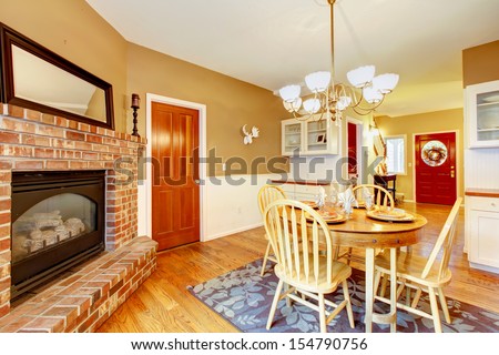 American farm house breakfast dining room area with brick fireplace.