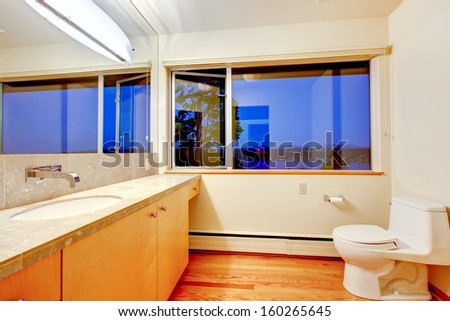 Modern newly renovated bathroom with blue evening window. Empty home, luxury real estate in Seattle.