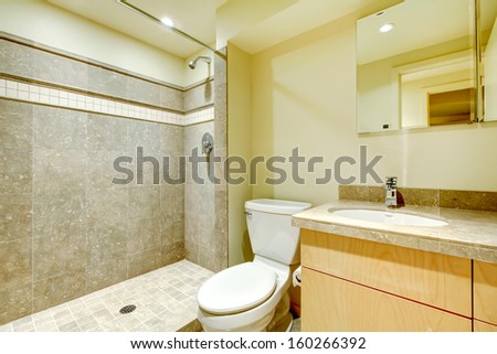 Modern new bathroom interior with grey tiles shower.