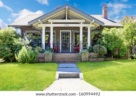 Small craftsman style American old house with front porch.