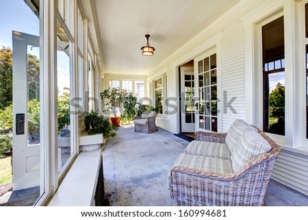 Front covered porch interior. Old classic American craftsman style home.