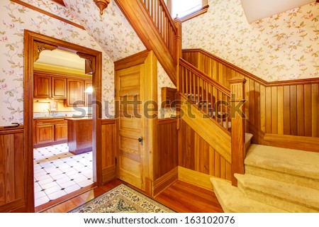 Hallway with staircase near entrance. Old American craftsman style home with lots of wood details.