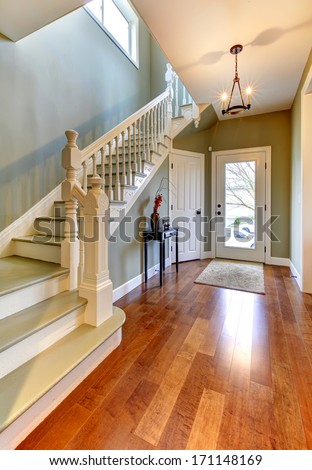 Home Interior With Green Walls. Main Hallway With Staircase And Cherry Hardwood Floor.