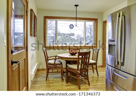 Cute Small Kitchen With Wooden Dinner Set And Wide Window. American Home Interior.