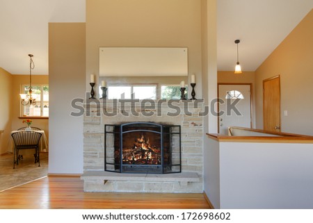 Light warm tones fireplace with a beige background in a bright comfortable living room